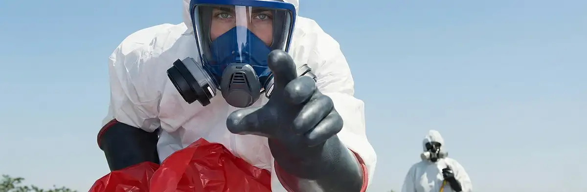 sewage clean up technician wearing protective gear handling biohazard materials in Austin, TX