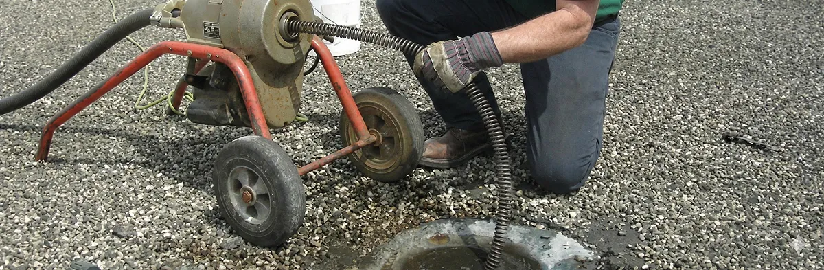 sewer rodding technician actively removing blockages from a sewer line in Austin, TX
