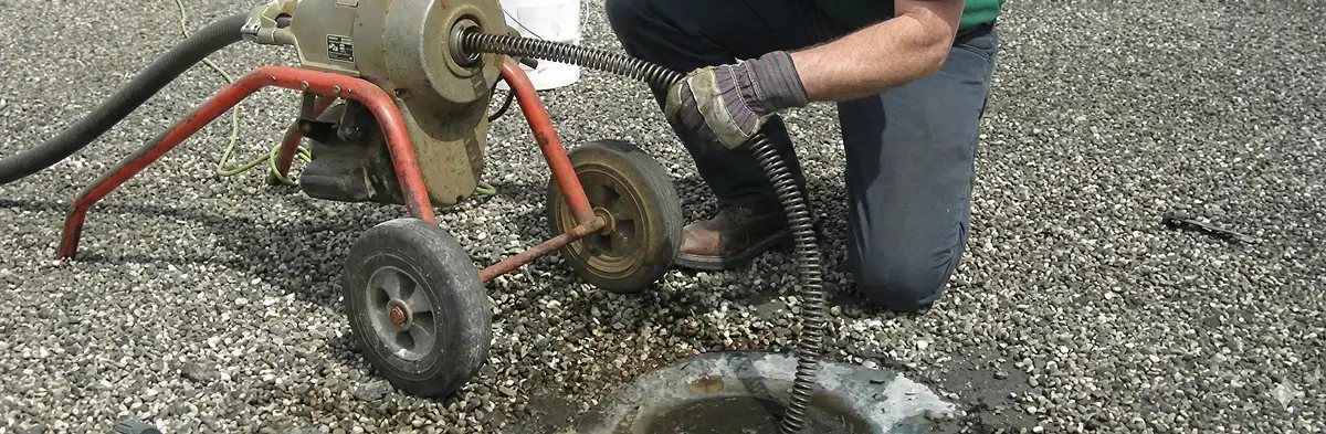 sewer rodding technician actively removing blockages from a sewer line in Austin, TX